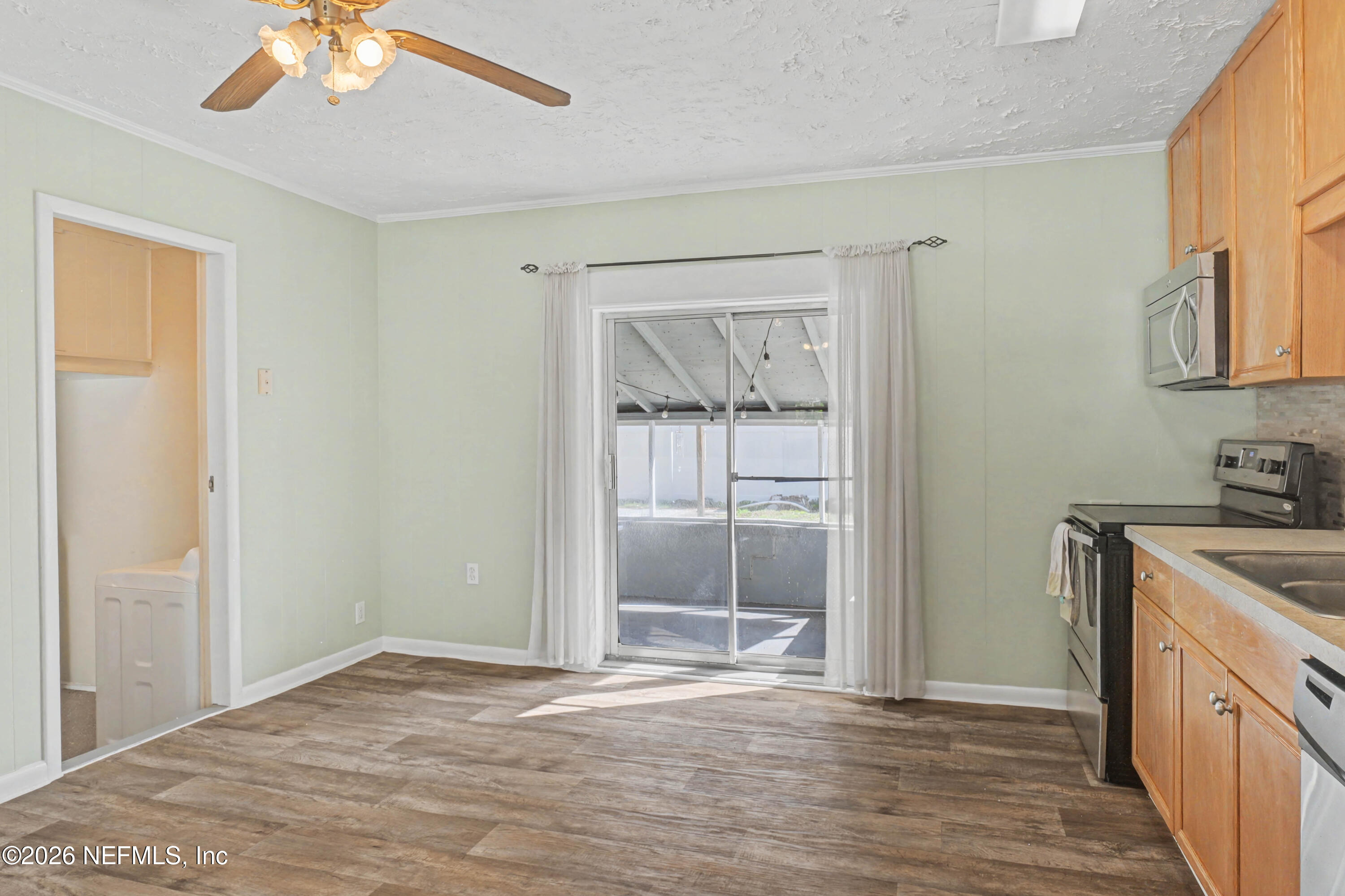 215 Orchis Road St. Augustine, FL 32086 - Photo 8 of 51 a view of a kitchen with a sink and cabinet with wooden floor