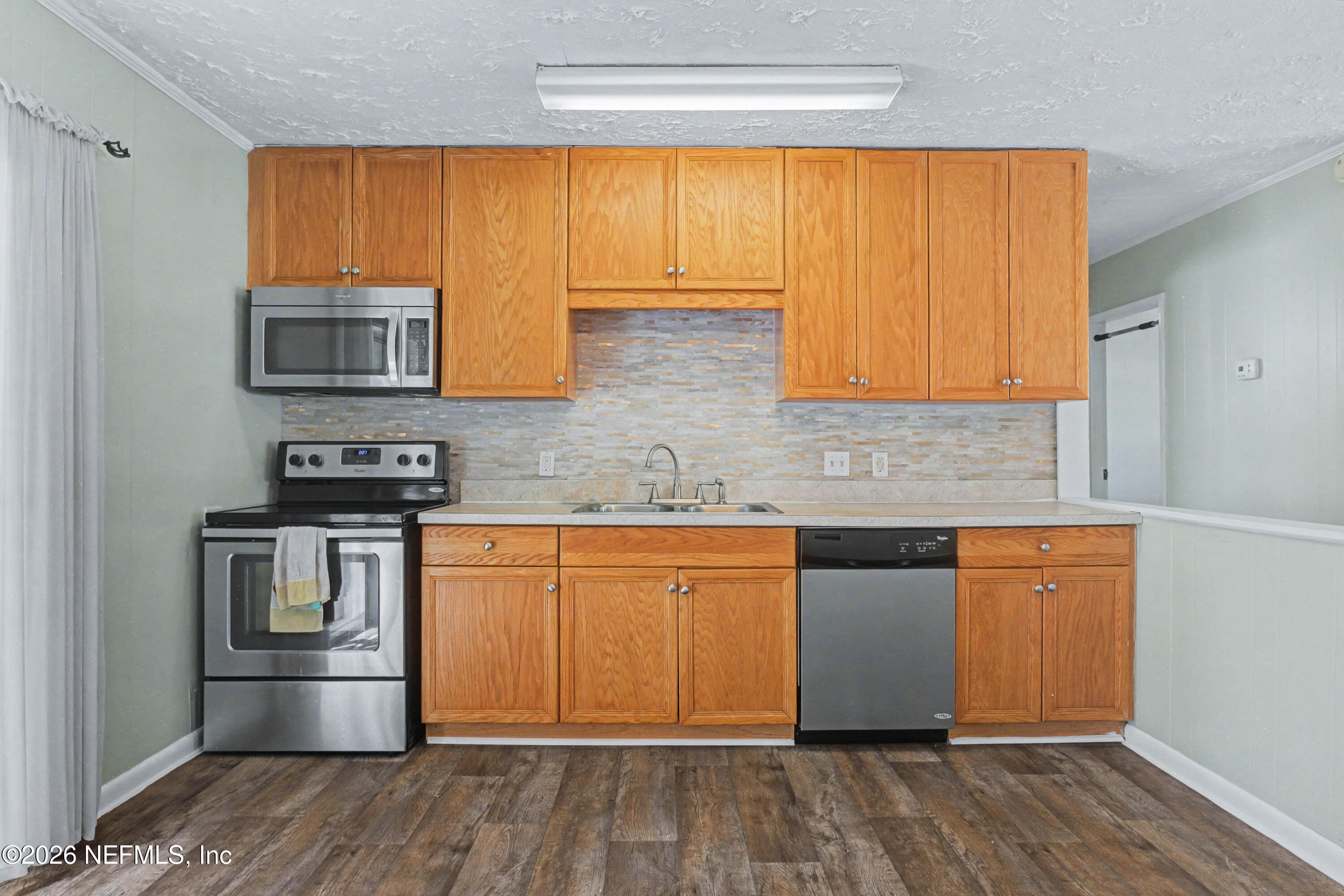 215 Orchis Road St. Augustine, FL 32086 - Photo 10 of 51 a kitchen with stainless steel appliances wooden floor and a sink