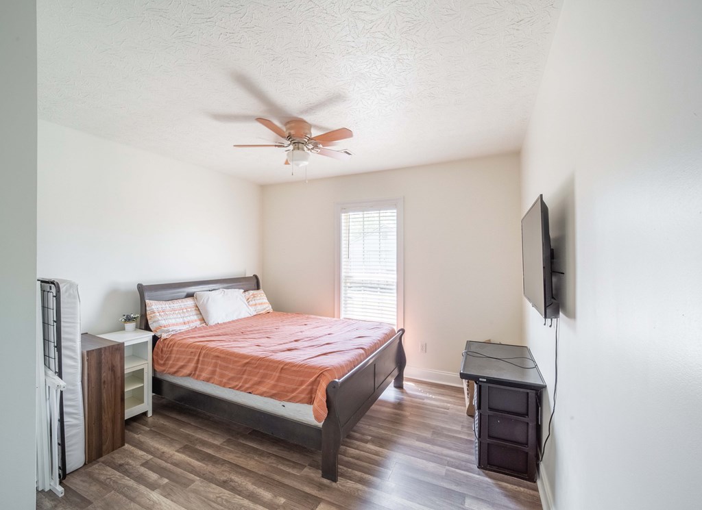 28 Whippoorwill Lane Fort Mitchell, AL 36856 - Photo 11 of 19 a bedroom with a bed and a flat screen tv