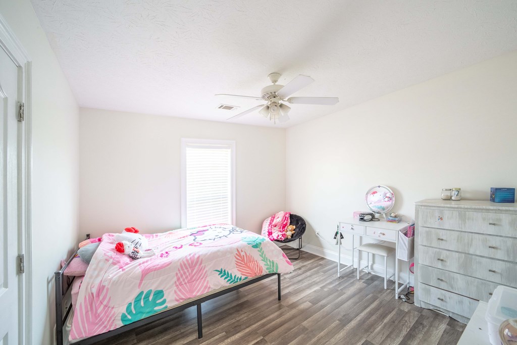 28 Whippoorwill Lane Fort Mitchell, AL 36856 - Photo 17 of 19 a bedroom with a bed and a chandelier