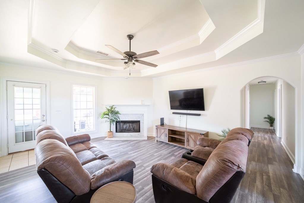 28 Whippoorwill Lane Fort Mitchell, AL 36856 - Photo 5 of 19 a living room with furniture a fireplace and a flat screen tv