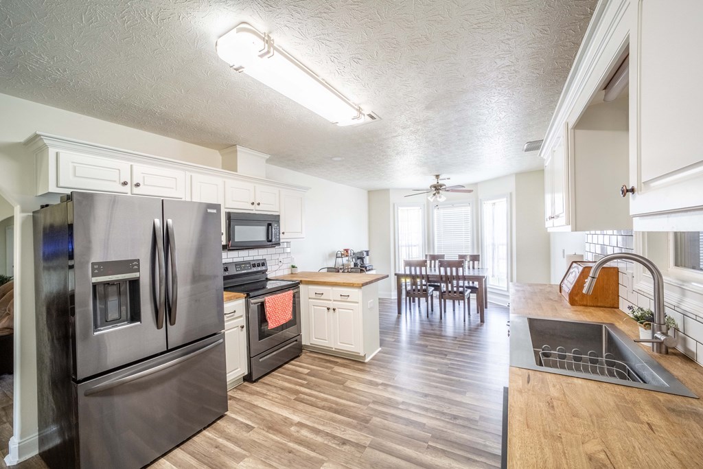 28 Whippoorwill Lane Fort Mitchell, AL 36856 - Photo 7 of 19 a kitchen with refrigerator and cabinets