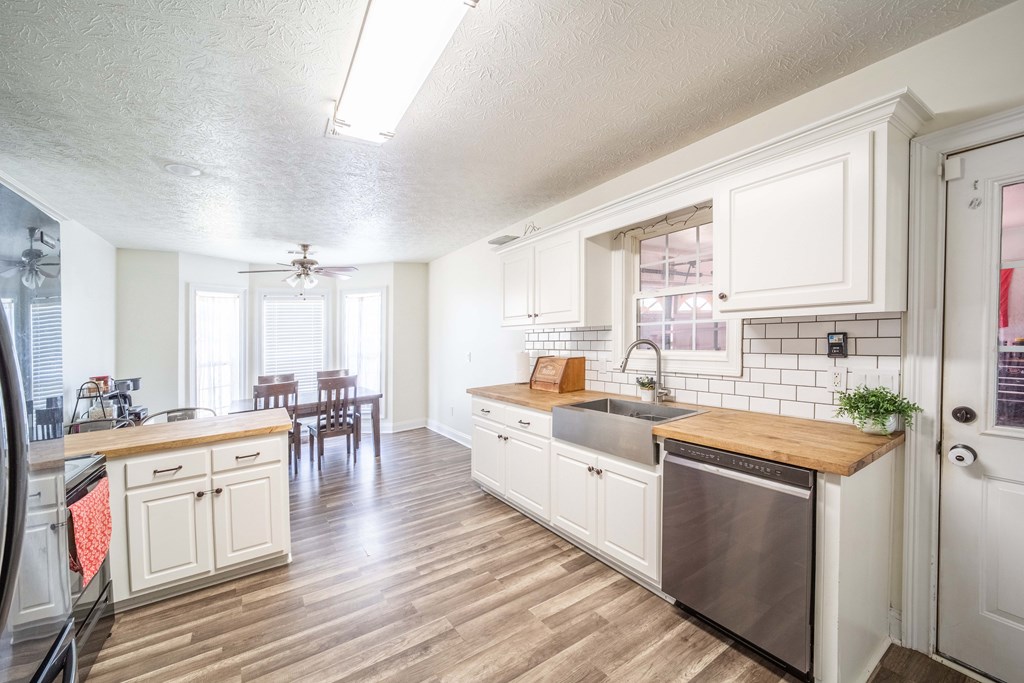 28 Whippoorwill Lane Fort Mitchell, AL 36856 - Photo 8 of 19 a large white kitchen with cabinets a sink and appliances