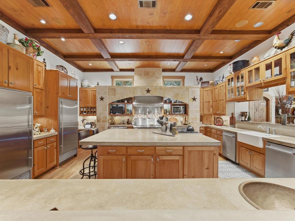 151 Trinity Bluffs Road Aledo, TX 76008 - Photo 13 of 40 a large kitchen with stainless steel appliances granite countertop a sink window and cabinets