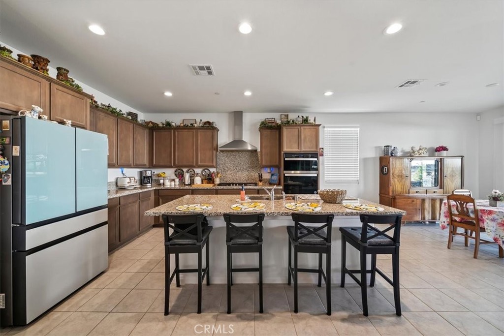 12766 Blush Court Riverside, CA 92503 - Photo 11 of 55 a kitchen with refrigerator and chairs