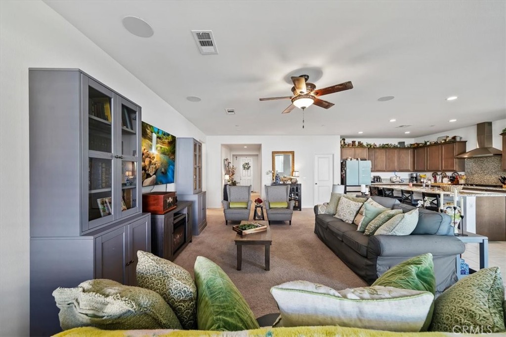 12766 Blush Court Riverside, CA 92503 - Photo 17 of 55 a living room with furniture kitchen view and a chandelier