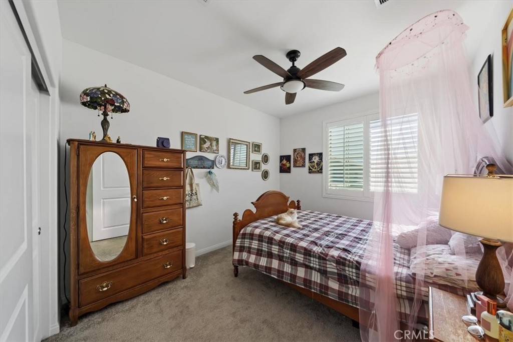 12766 Blush Court Riverside, CA 92503 - Photo 25 of 55 a bedroom with a bed and a chandelier