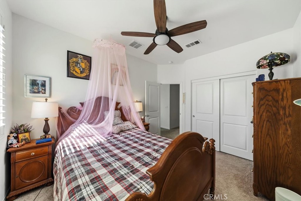 12766 Blush Court Riverside, CA 92503 - Photo 26 of 55 a bedroom with a bed and a chandelier