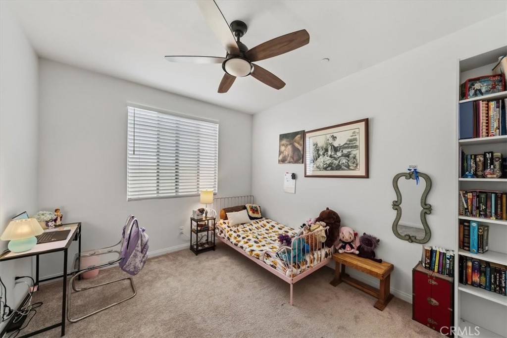 12766 Blush Court Riverside, CA 92503 - Photo 30 of 55 a bedroom with furniture and a book shelf
