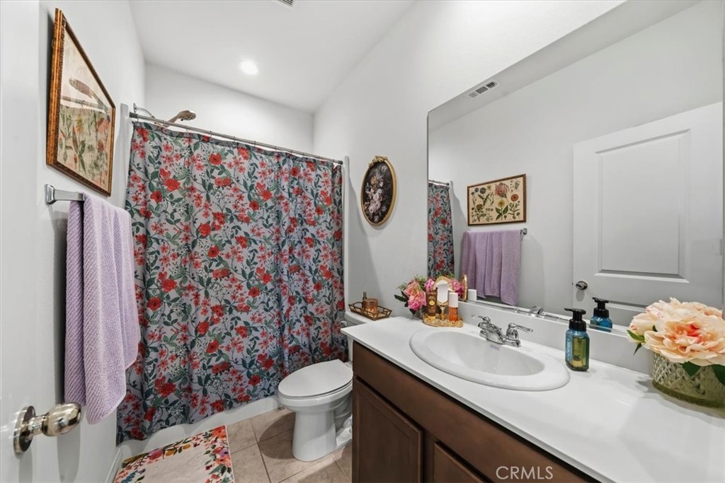 12766 Blush Court Riverside, CA 92503 - Photo 31 of 55 a bathroom with a sink vanity mirror and toilet