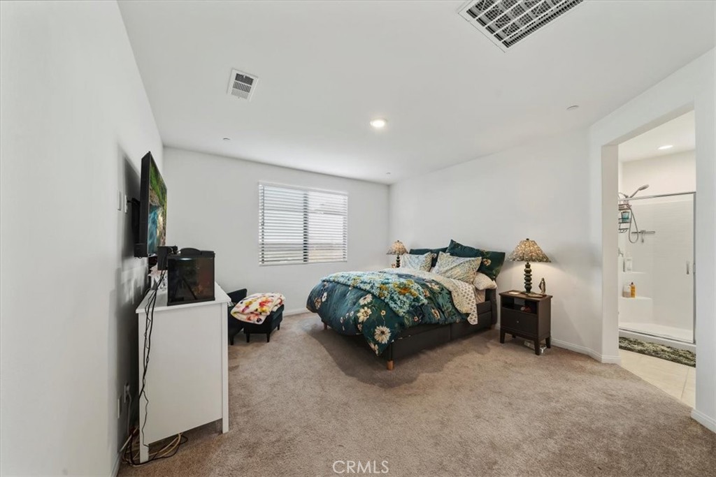 12766 Blush Court Riverside, CA 92503 - Photo 32 of 55 a bedroom with a bed and a lamp