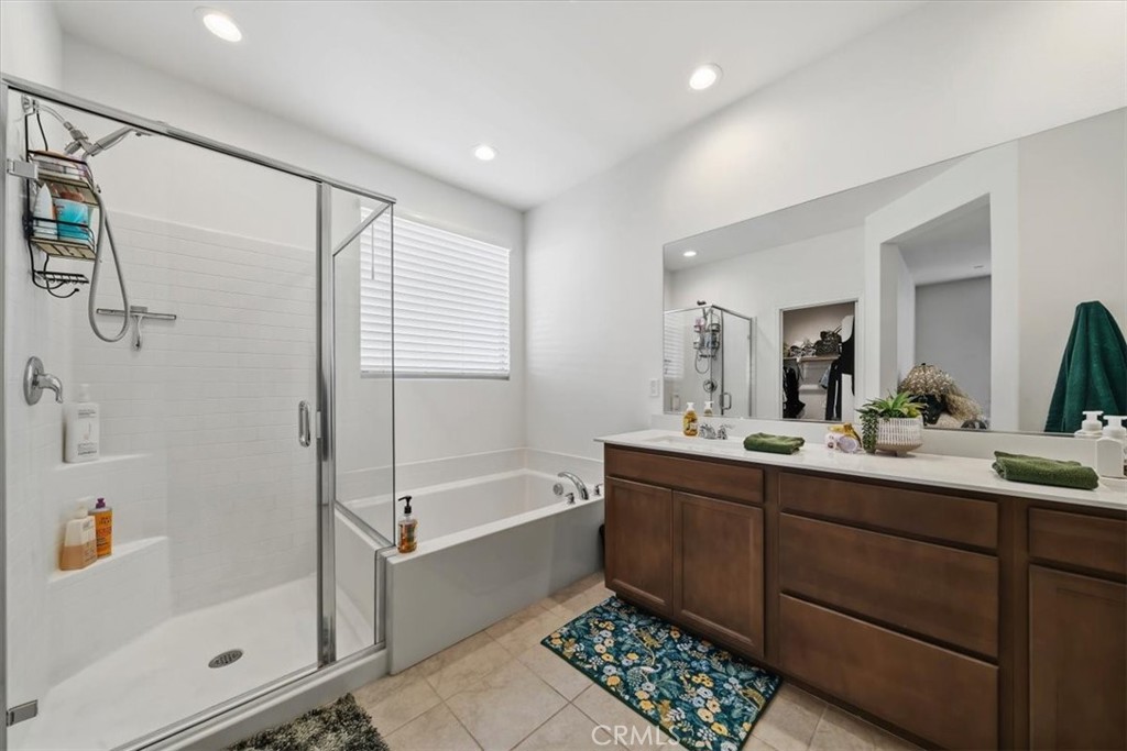 12766 Blush Court Riverside, CA 92503 - Photo 34 of 55 a bathroom with a tub sink shower and mirror