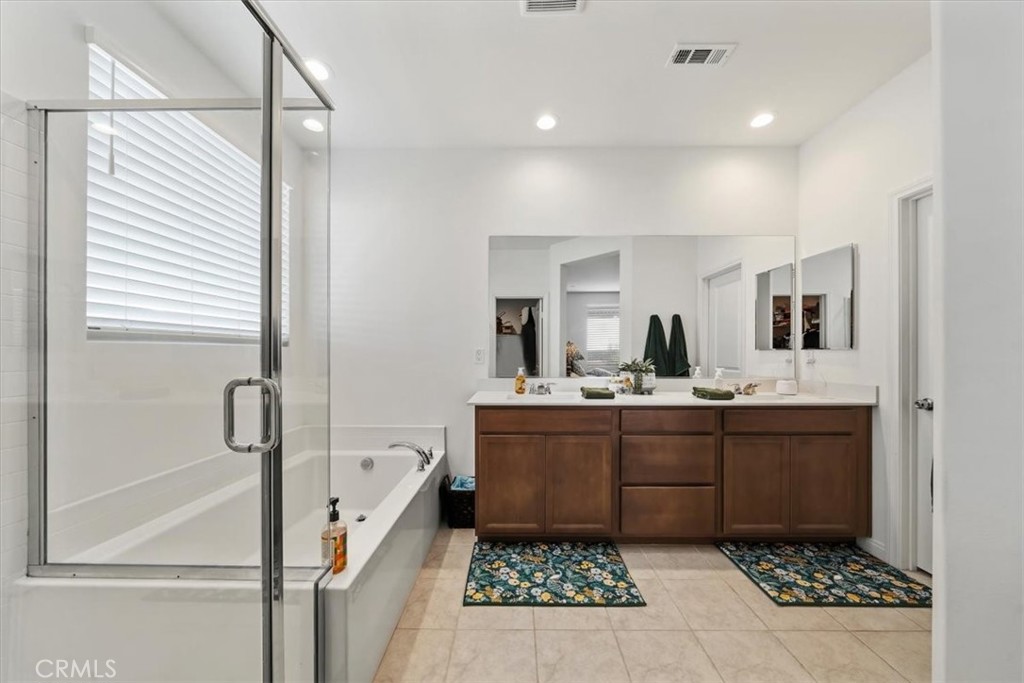 12766 Blush Court Riverside, CA 92503 - Photo 35 of 55 a bathroom with a tub sink and mirror
