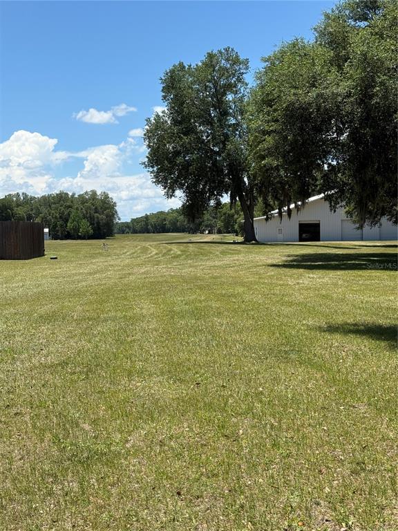 7390 South Mc Alpin Road McAlpin, FL 32062 - Photo 34 of 53 a view of a field with trees in the background