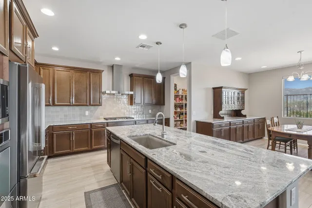 a kitchen with counter top space appliances and furniture