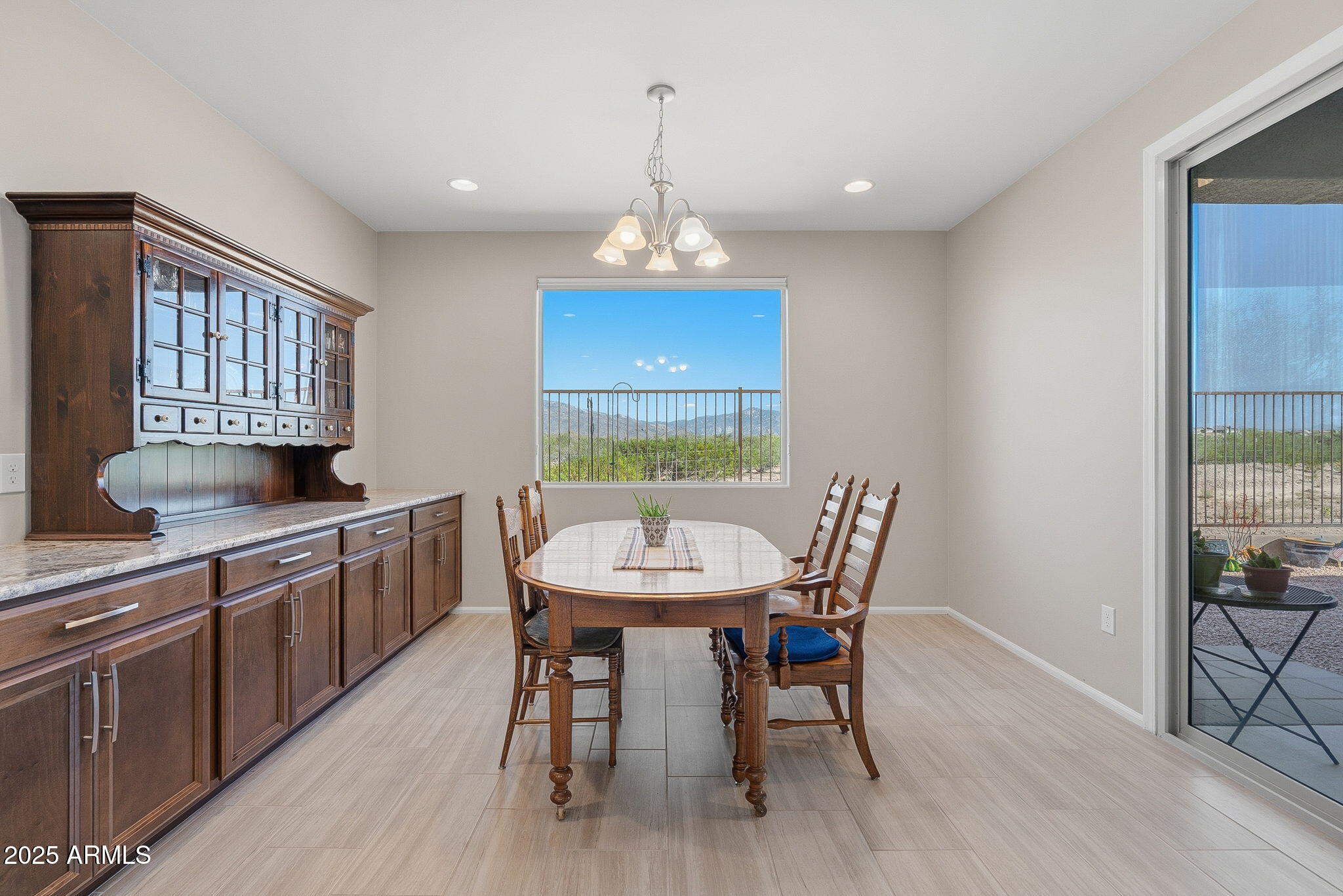 5439 South Sierra Prieta Trail Tucson, AZ 85747 - Photo 13 of 71 a dining room with furniture a window and a chandelier