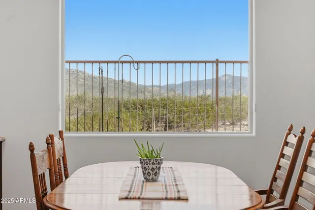 a view of kitchen with granite countertop window and dining table