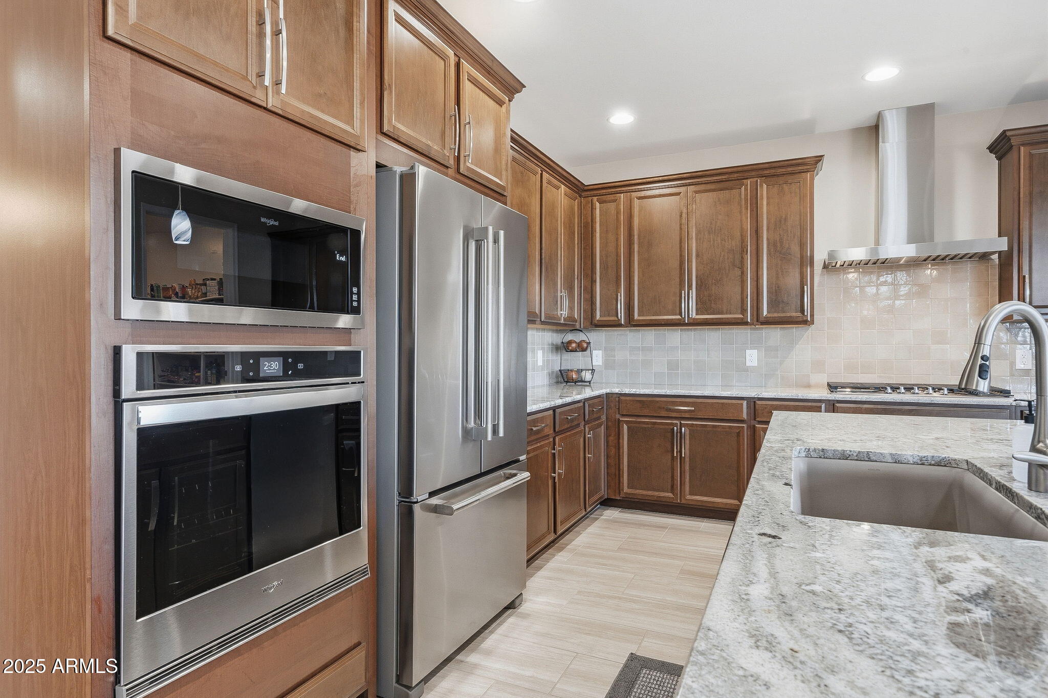5439 South Sierra Prieta Trail Tucson, AZ 85747 - Photo 17 of 71 a kitchen with stainless steel appliances granite countertop a stove and a refrigerator