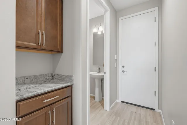 a spacious bedroom with a bed a table and chair