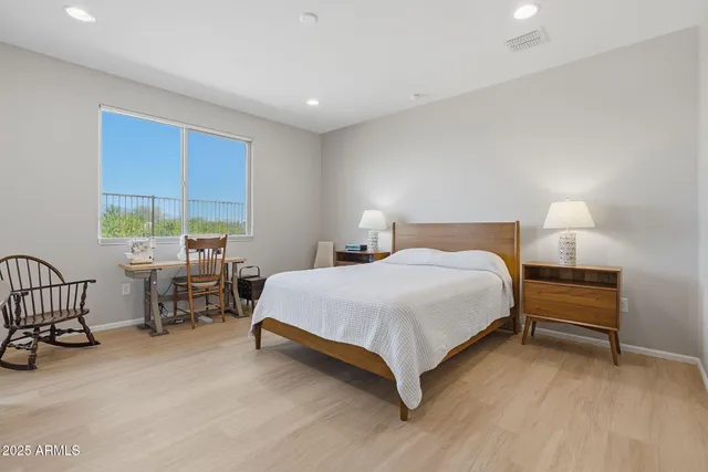 a bedroom with a bed and a desk