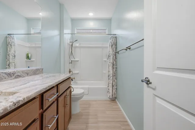 a dining room with furniture and a floor to ceiling window