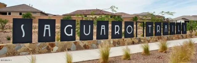 a view of a workspace with furniture and a ceiling fan
