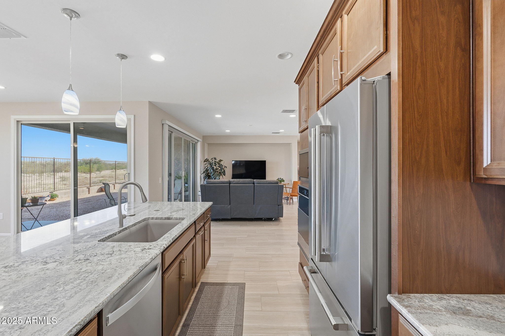 5439 South Sierra Prieta Trail Tucson, AZ 85747 - Photo 55 of 71 a kitchen with stainless steel appliances granite countertop a sink and a refrigerator
