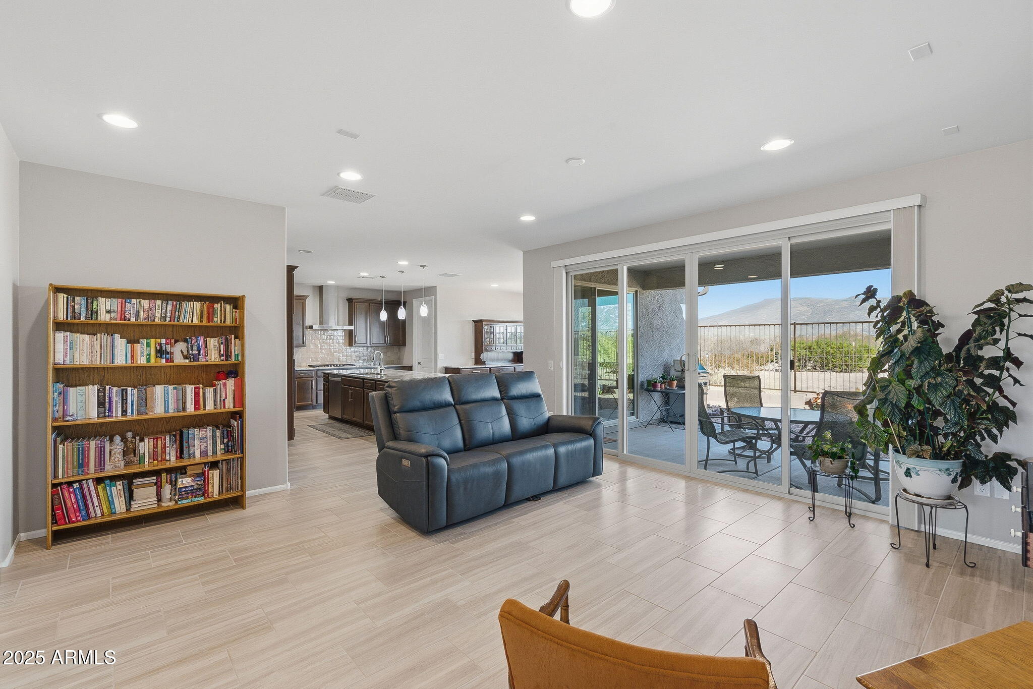 5439 South Sierra Prieta Trail Tucson, AZ 85747 - Photo 58 of 71 a living room with furniture and a book shelf