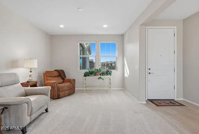 a living room with furniture and kitchen view