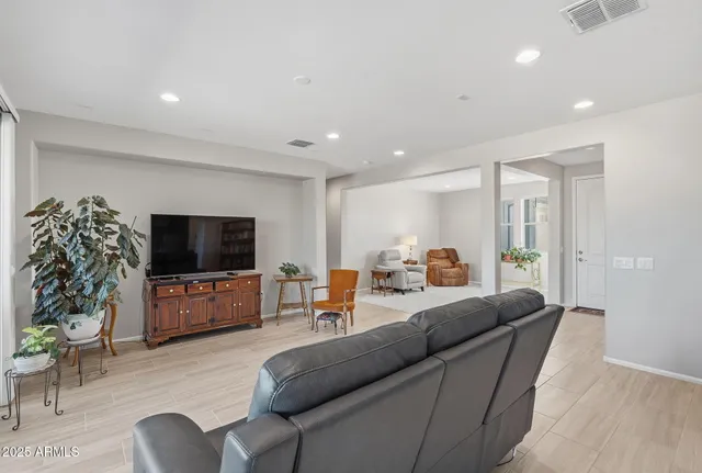 a large kitchen with stainless steel appliances kitchen island a large counter top and a stove top oven