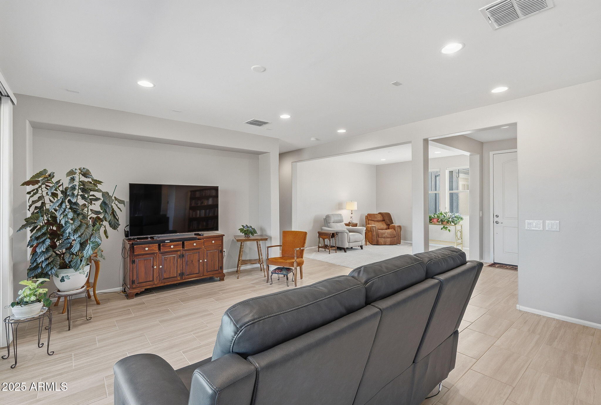 5439 South Sierra Prieta Trail Tucson, AZ 85747 - Photo 8 of 71 a living room with furniture and a flat screen tv