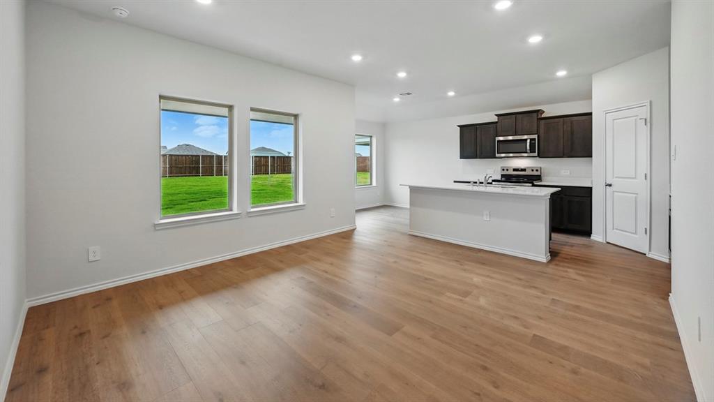 3925 Oakcrest Lane Princeton, TX 75407 - Photo 17 of 35 a view of a kitchen with microwave and a stove