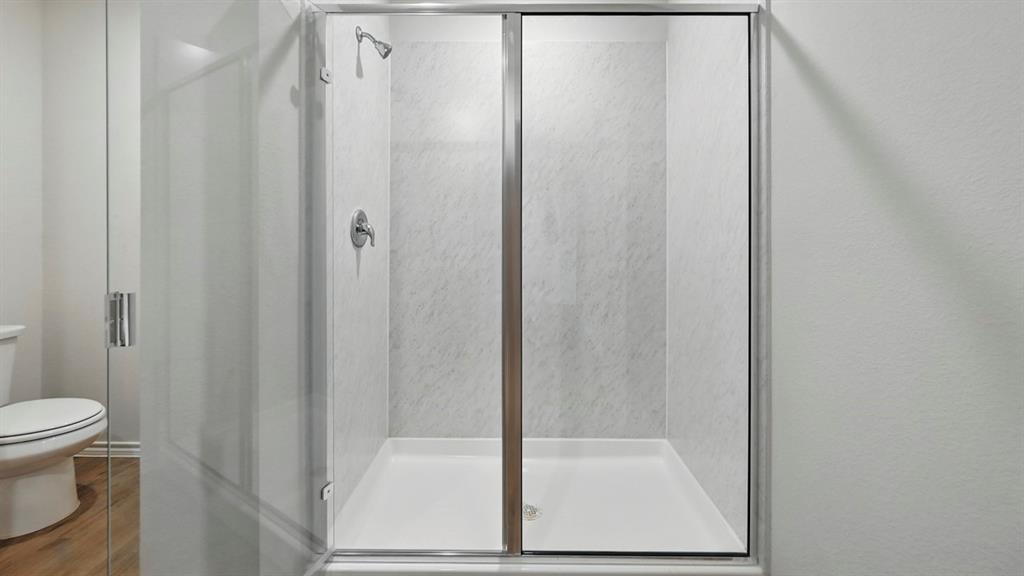 3925 Oakcrest Lane Princeton, TX 75407 - Photo 3 of 35 a bathroom with a shower and a toilet