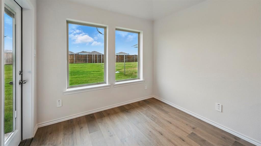 3925 Oakcrest Lane Princeton, TX 75407 - Photo 32 of 35 a view of an empty room with wooden floor and a window