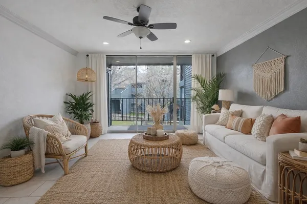 a living room with furniture and a potted plant