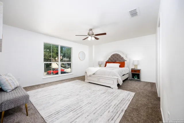 a bedroom with a bed and a window