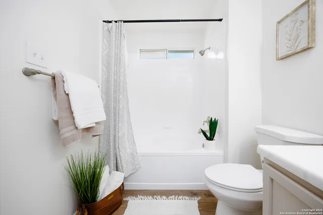 a bathroom with a toilet a sink and shower