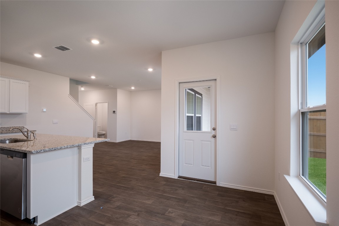 15009 Welsh Cob St Manor, Unit A Manor, TX 78653 - Photo 14 of 24 a view of a livingroom with kitchen and furniture