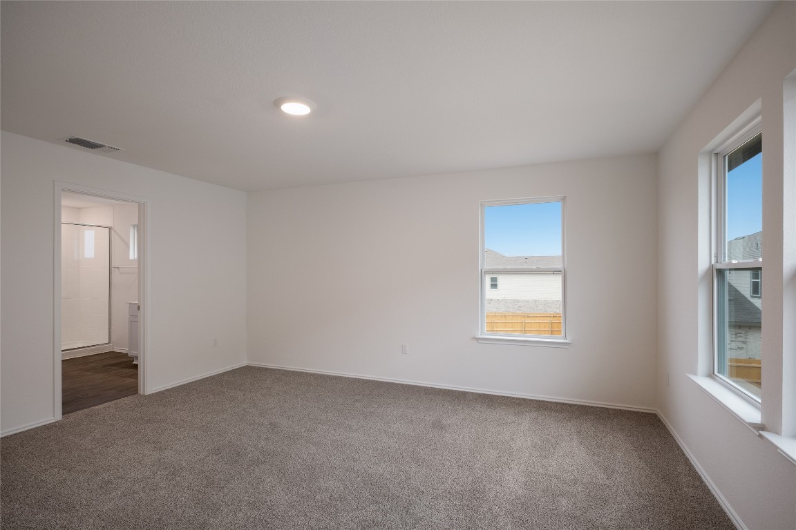 15009 Welsh Cob St Manor, Unit A Manor, TX 78653 - Photo 15 of 24 an empty room with windows