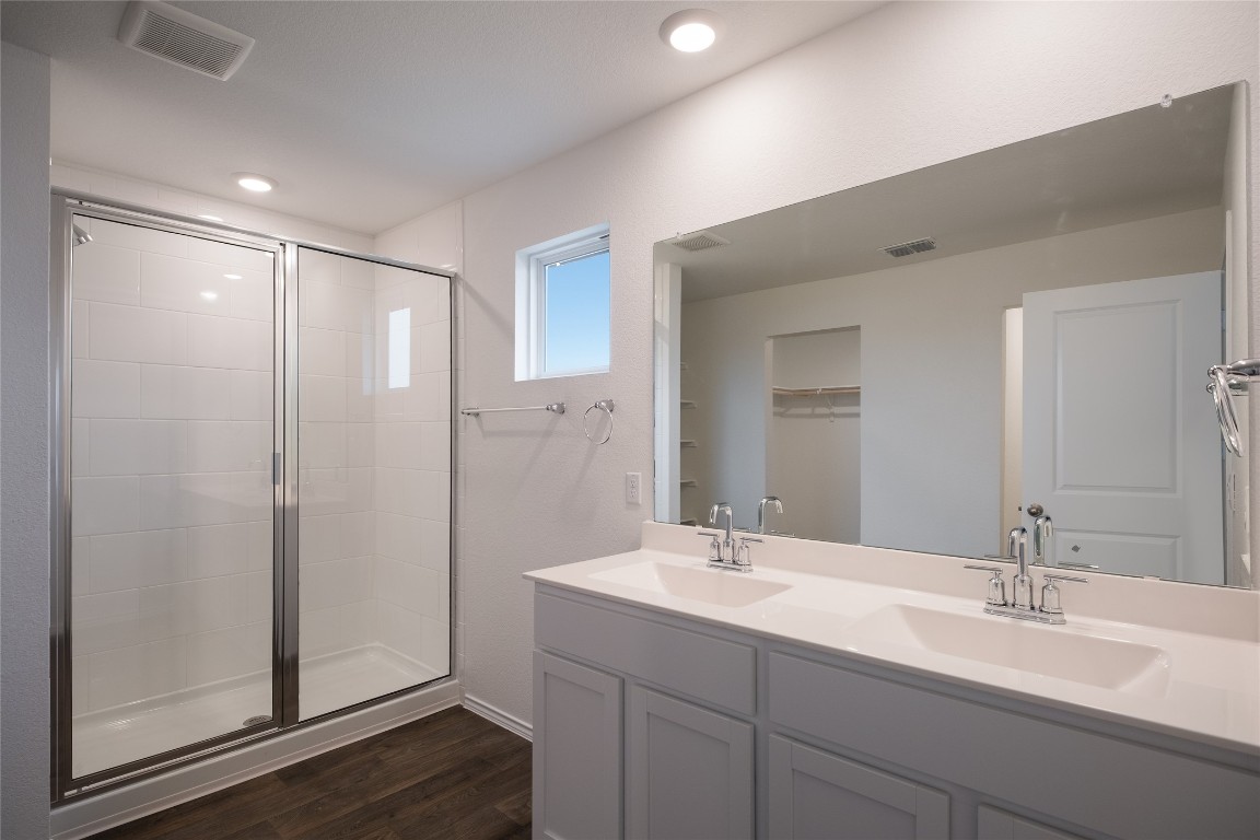 15009 Welsh Cob St Manor, Unit A Manor, TX 78653 - Photo 17 of 24 a bathroom with a double vanity sink mirror and shower
