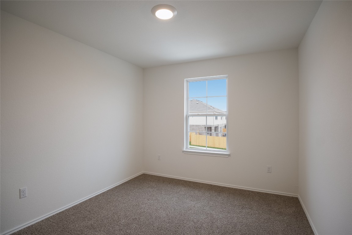 15009 Welsh Cob St Manor, Unit A Manor, TX 78653 - Photo 19 of 24 an empty room with a window