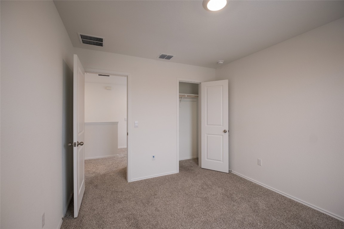 15009 Welsh Cob St Manor, Unit A Manor, TX 78653 - Photo 20 of 24 an empty room with closet area