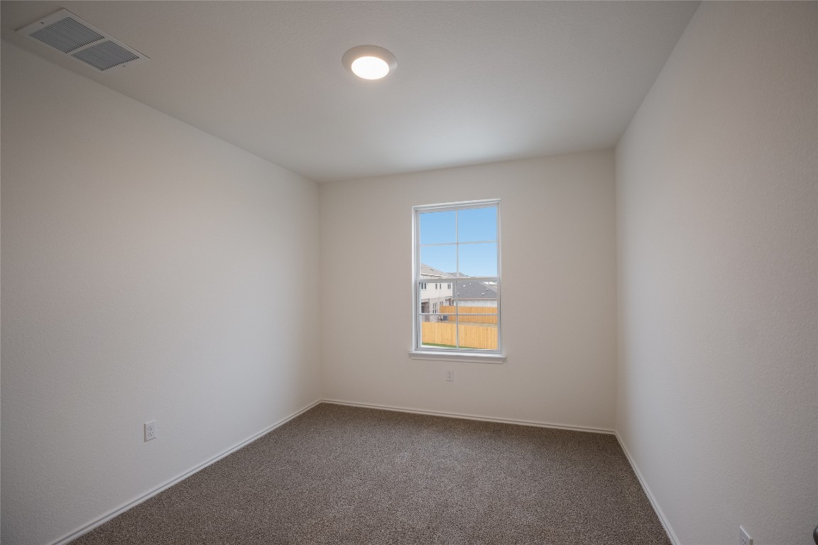 15009 Welsh Cob St Manor, Unit A Manor, TX 78653 - Photo 22 of 24 an empty room with a window