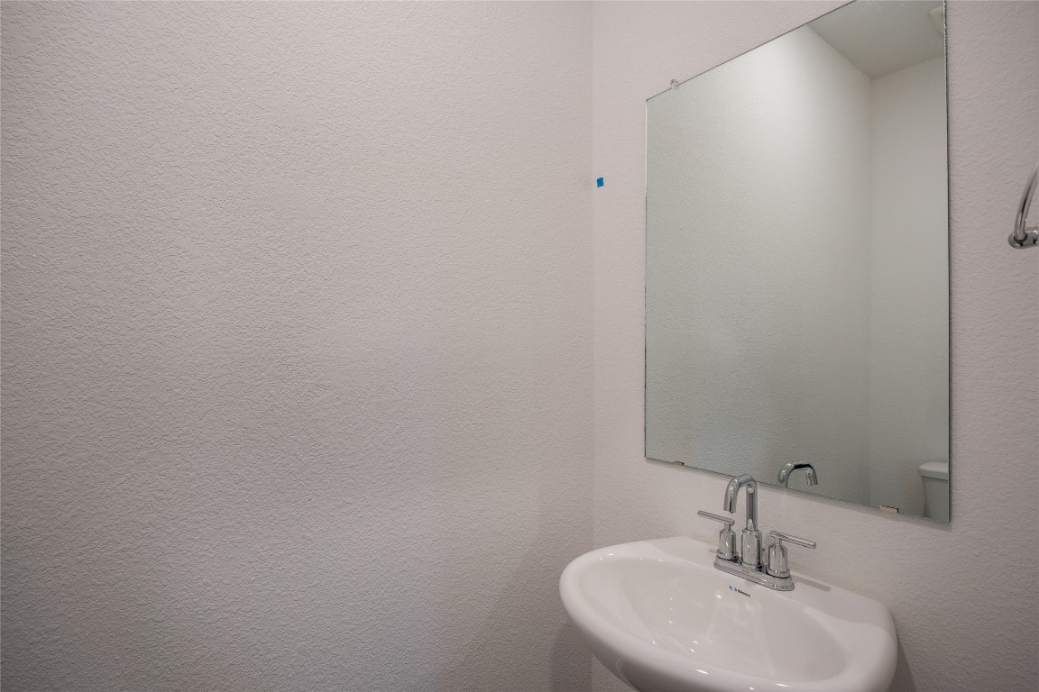 15009 Welsh Cob St Manor, Unit A Manor, TX 78653 - Photo 6 of 24 a bathroom with a sink and a mirror