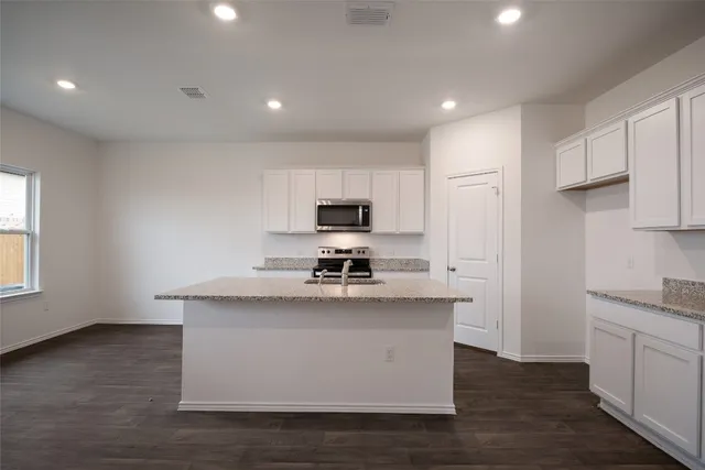 a kitchen with a sink and a window