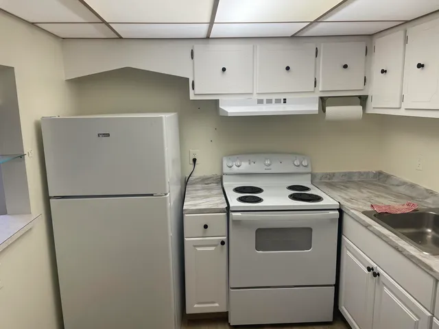 a white refrigerator freezer sitting inside of a kitchen