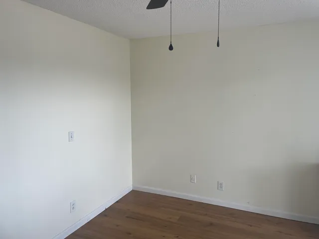 a view of a room with wooden floor