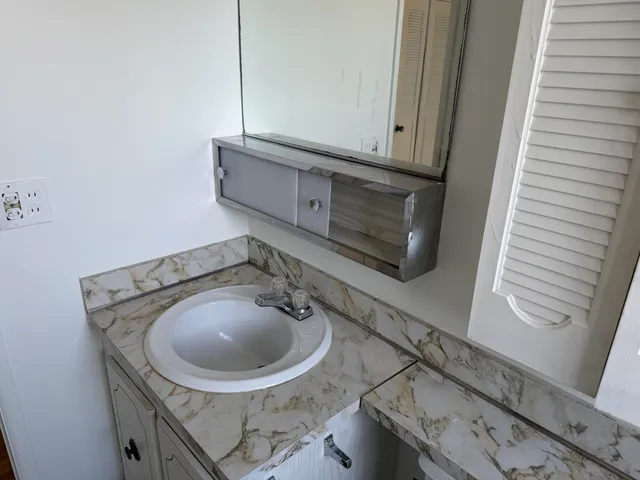 a utility room with sink dryer and washer