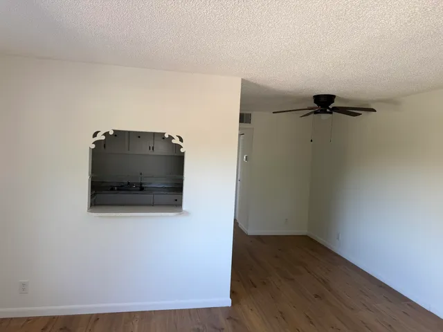 a view of an empty room and wooden floor