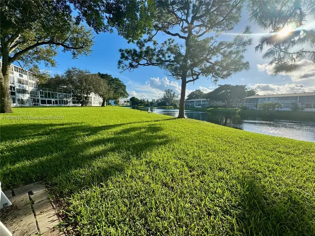 a bathroom with a granite countertop sink toilet a mirror and shower